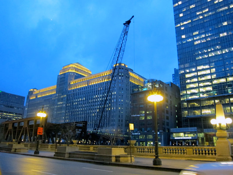 The Merchandise Mart, its roofline alive with light in the blue hour.