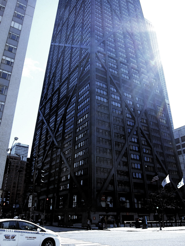 The sun peeking out from one side of the austere, steel-banded Hancock Building.Holding together (the Hancock Building, Chicago), © 2013 Celia Her City