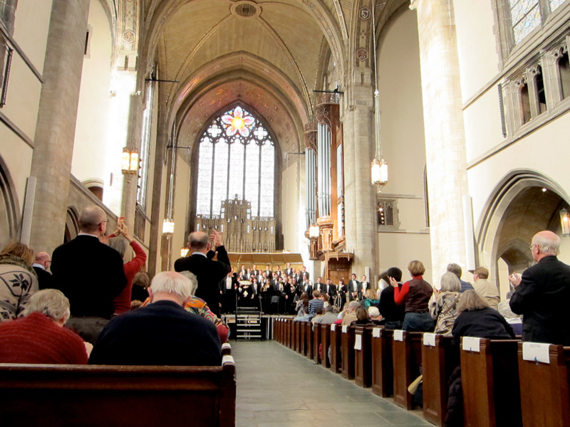 Crowds applauding at the conclusion of the concert at Rockefeller Chapel.