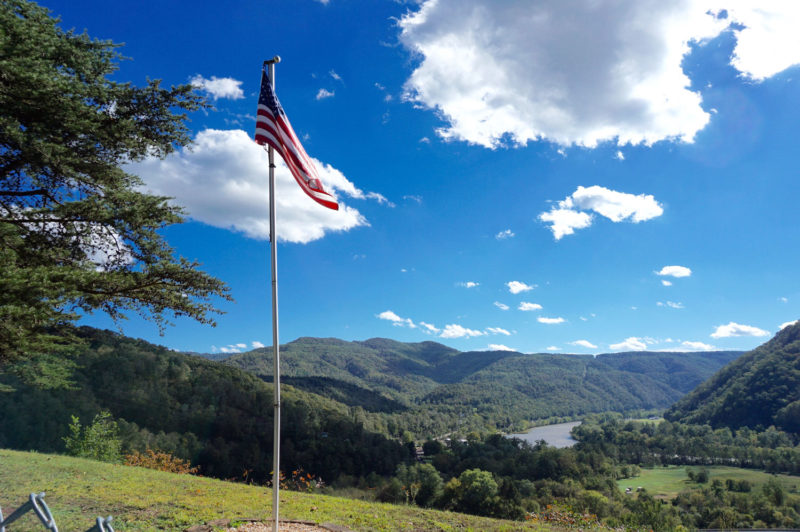 View of West Virginia countryside from a hilltop cemetery with US flag